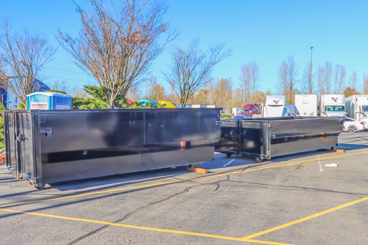 Professional dumpster rental service with roll-off container on residential driveway in Latrobe